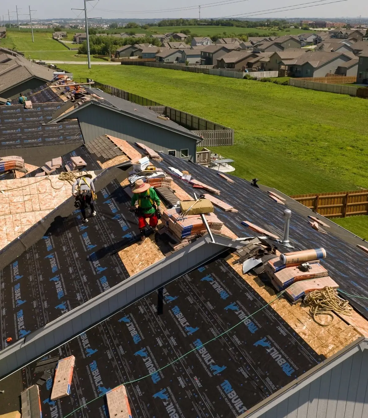 A Monarch crew roofing a new home in a growing subdivision