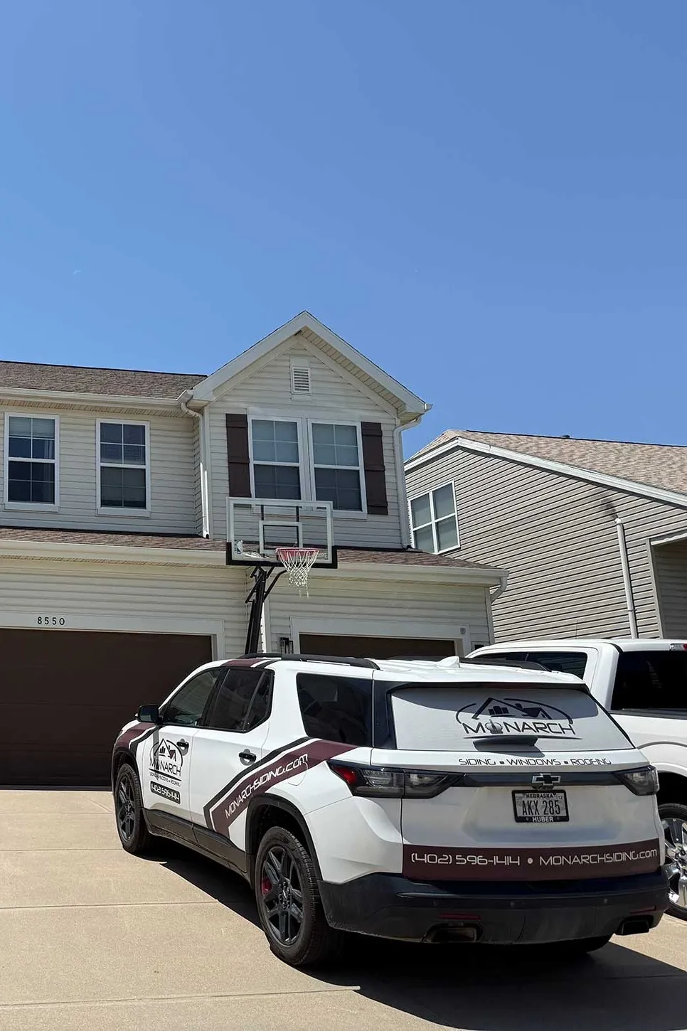 New siding going up over house wrap on a two-story home