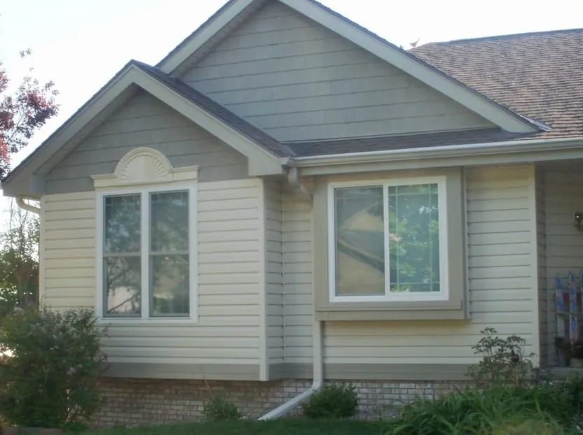 Ranch home re-sided in light lap siding — after