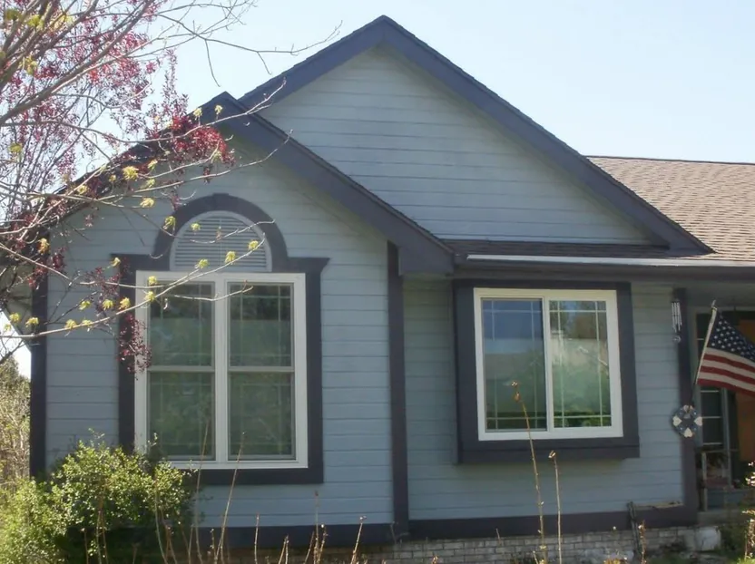 Ranch home re-sided in light lap siding — before
