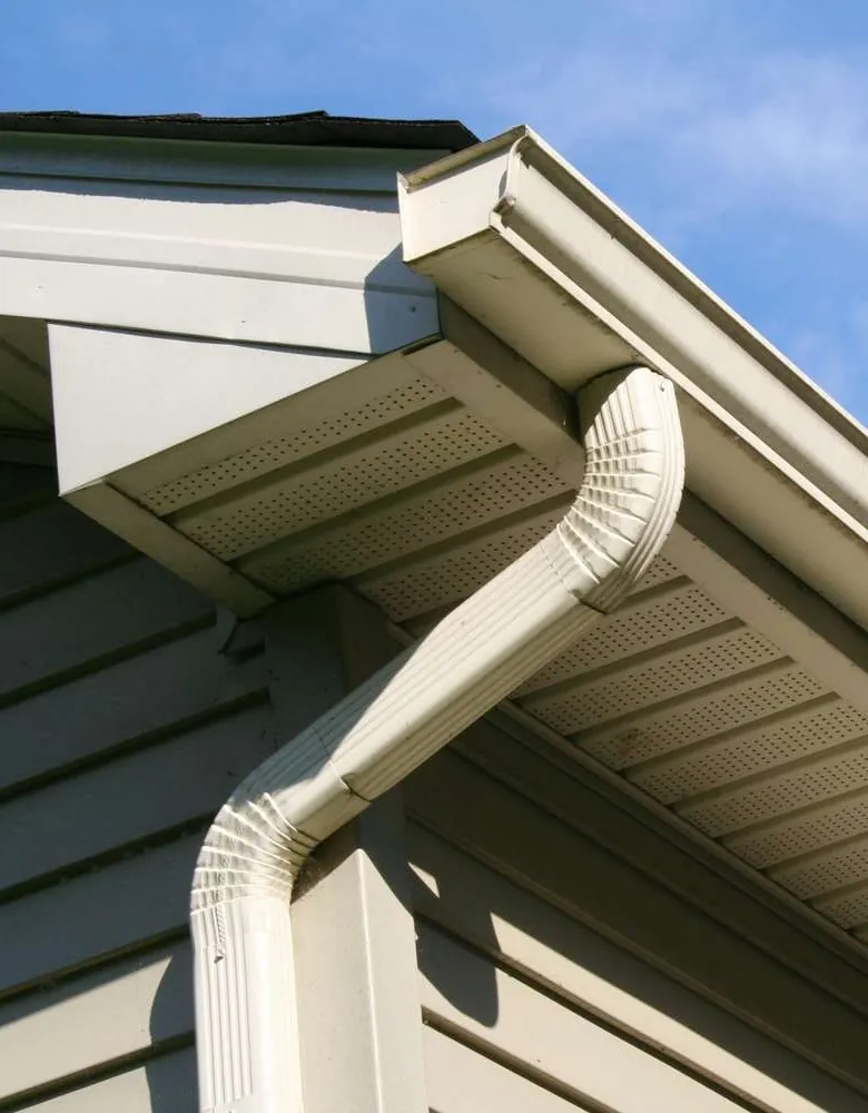 A downspout running from the gutter past the soffit