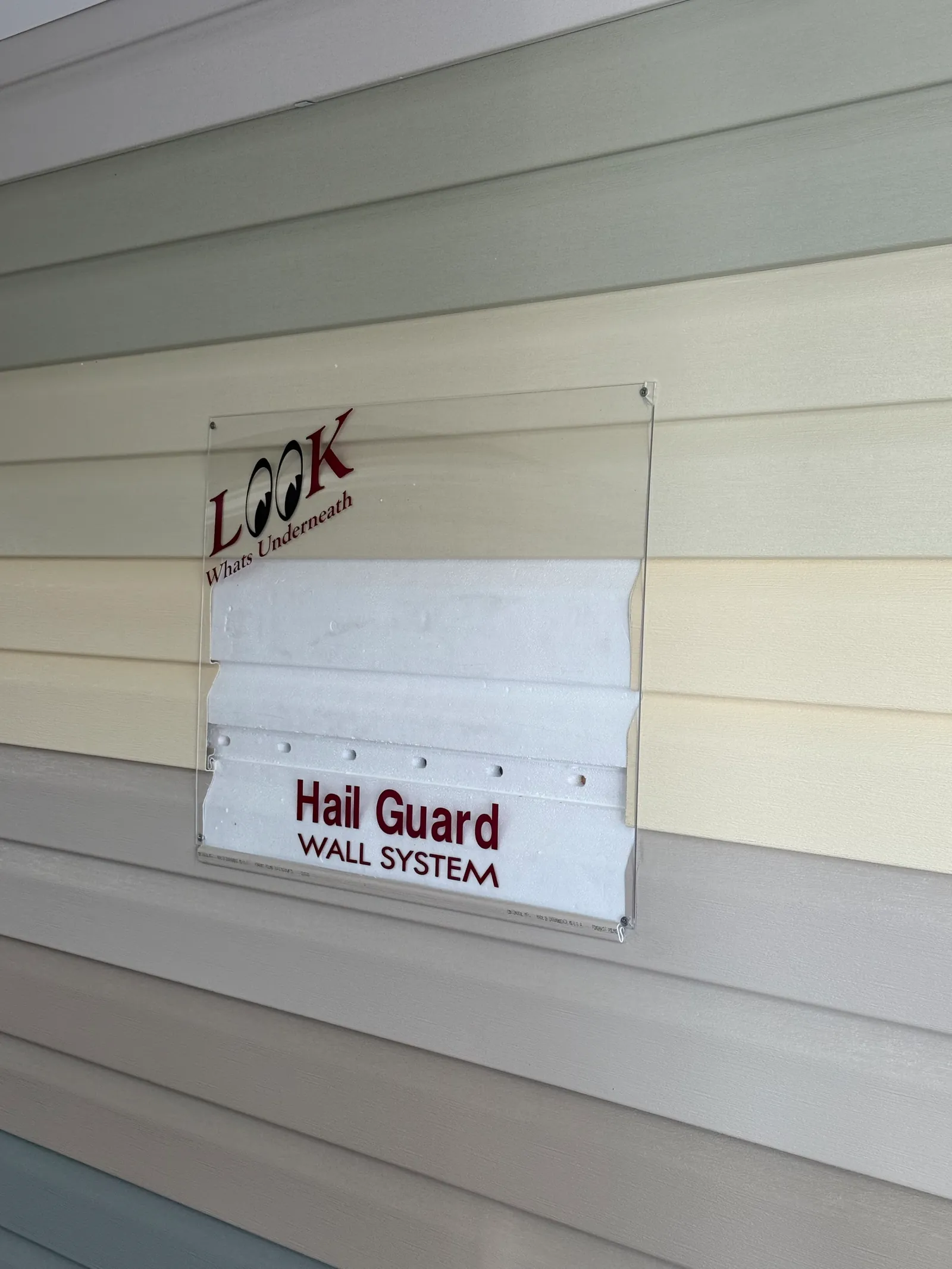 Hail Guard Wall System® display in the Monarch showroom, showing the foam layer under the siding