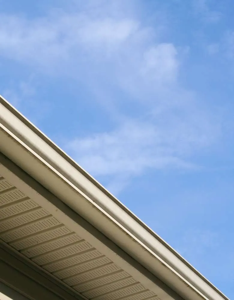 Vented soffit and fascia under a roof eave